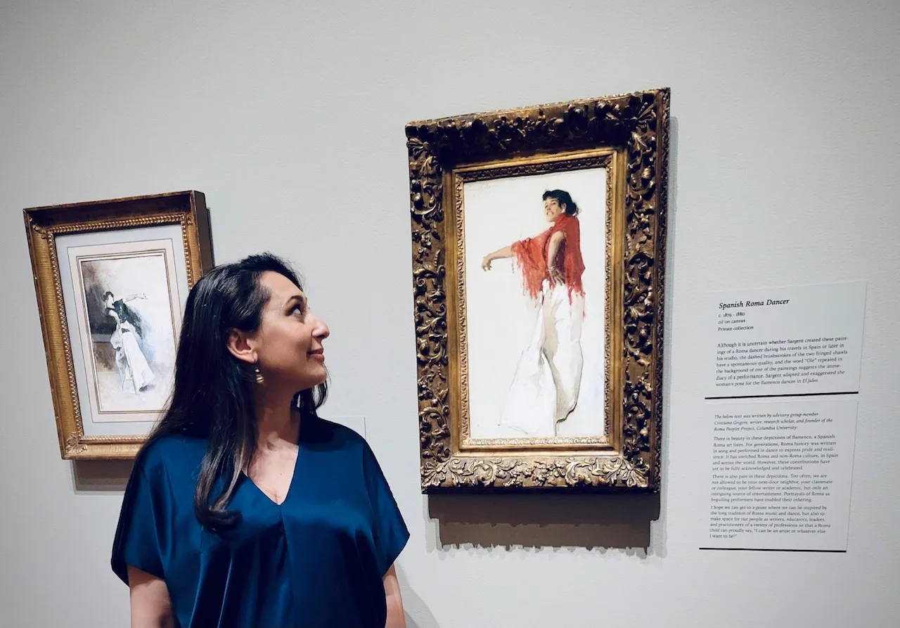 Scholar Cristiana Grigore in front of the modified label for John Singer Sargent’s “Spanish Roma Dancer” in the exhibition Sargent and Spain at the National Gallery of Art in Washington, DC.