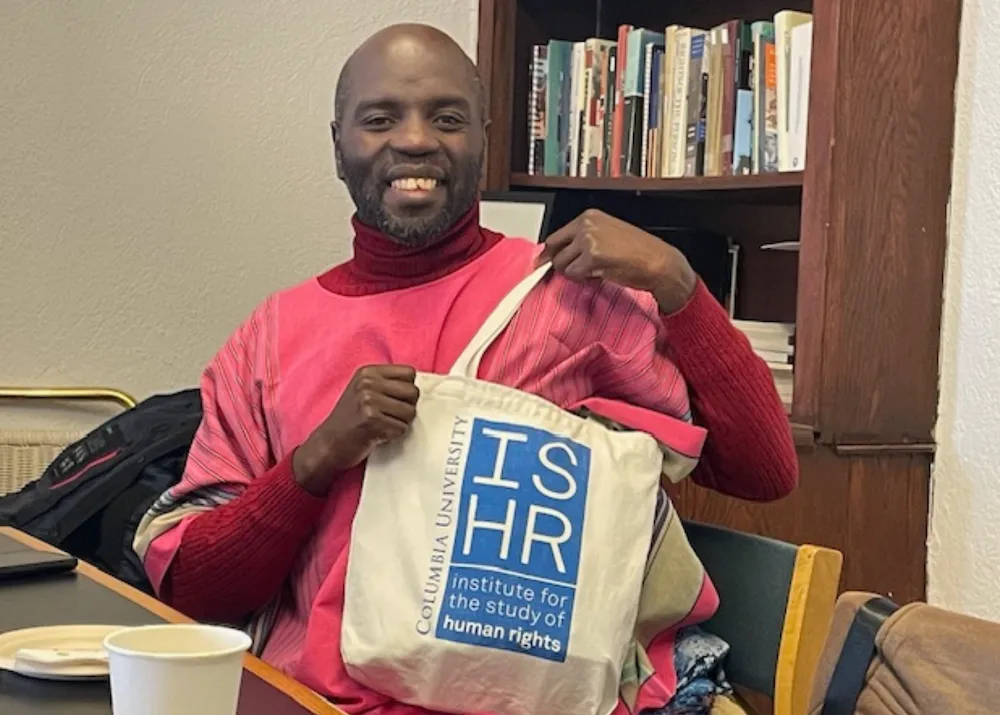 Jeffrey Walimba Wambaya with ISHR tote bag