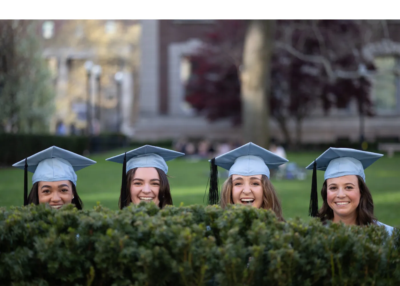 Picture of four women in graduation caps