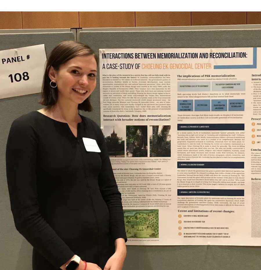 A student standing in front of a poster
