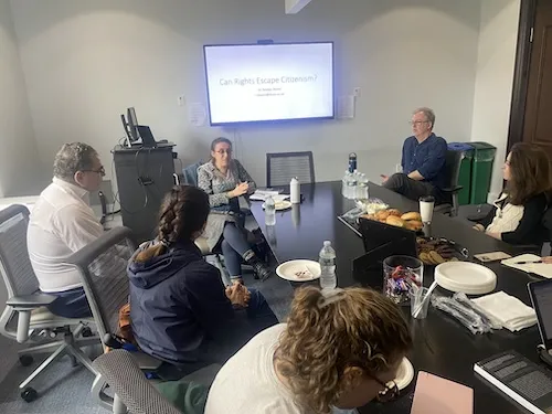 Person speaking to a group of people.